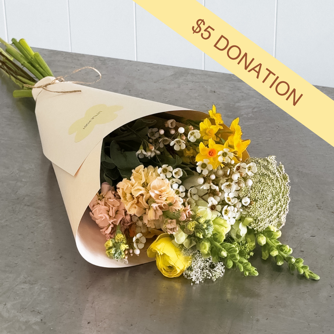 Yellow Daffodil Day donation posy. The flower arrangement includes yellow, white and green flowers. $5 from every posy will be donated to the cancel council.